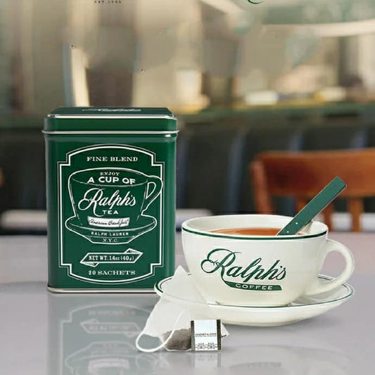 DESIGNER TIN, TEA CUP AND SAUCER ONLY AVAILABLE AT RALPH'S COFFEE